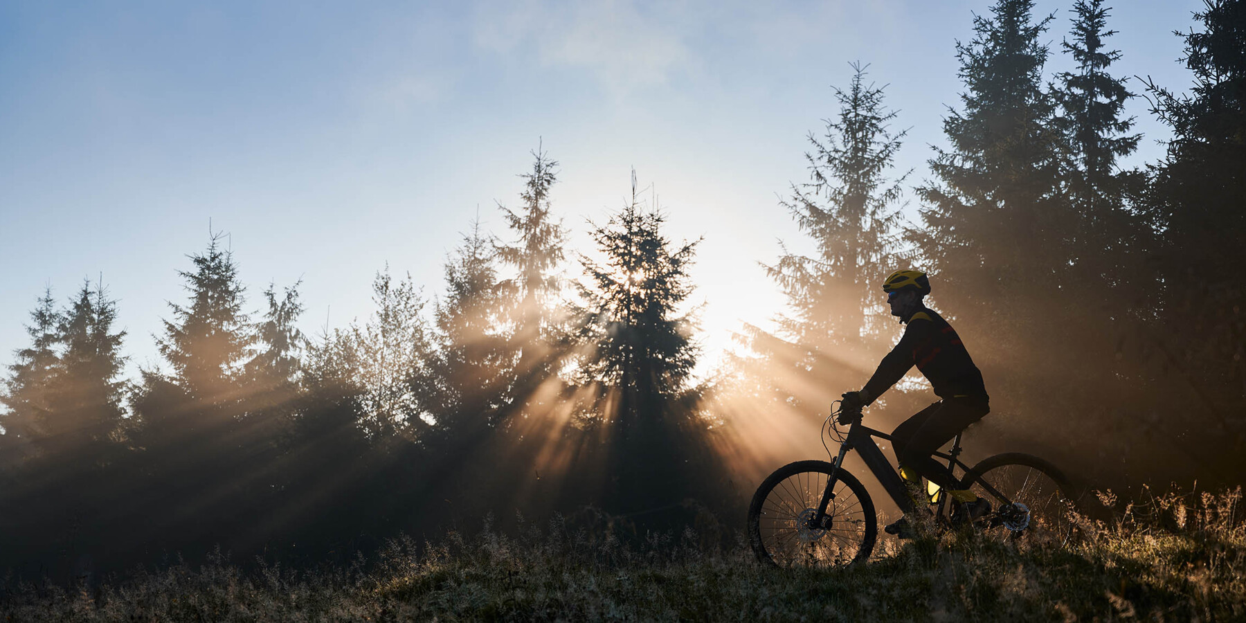 young-man-riding-bicycle-mountains-early-morning