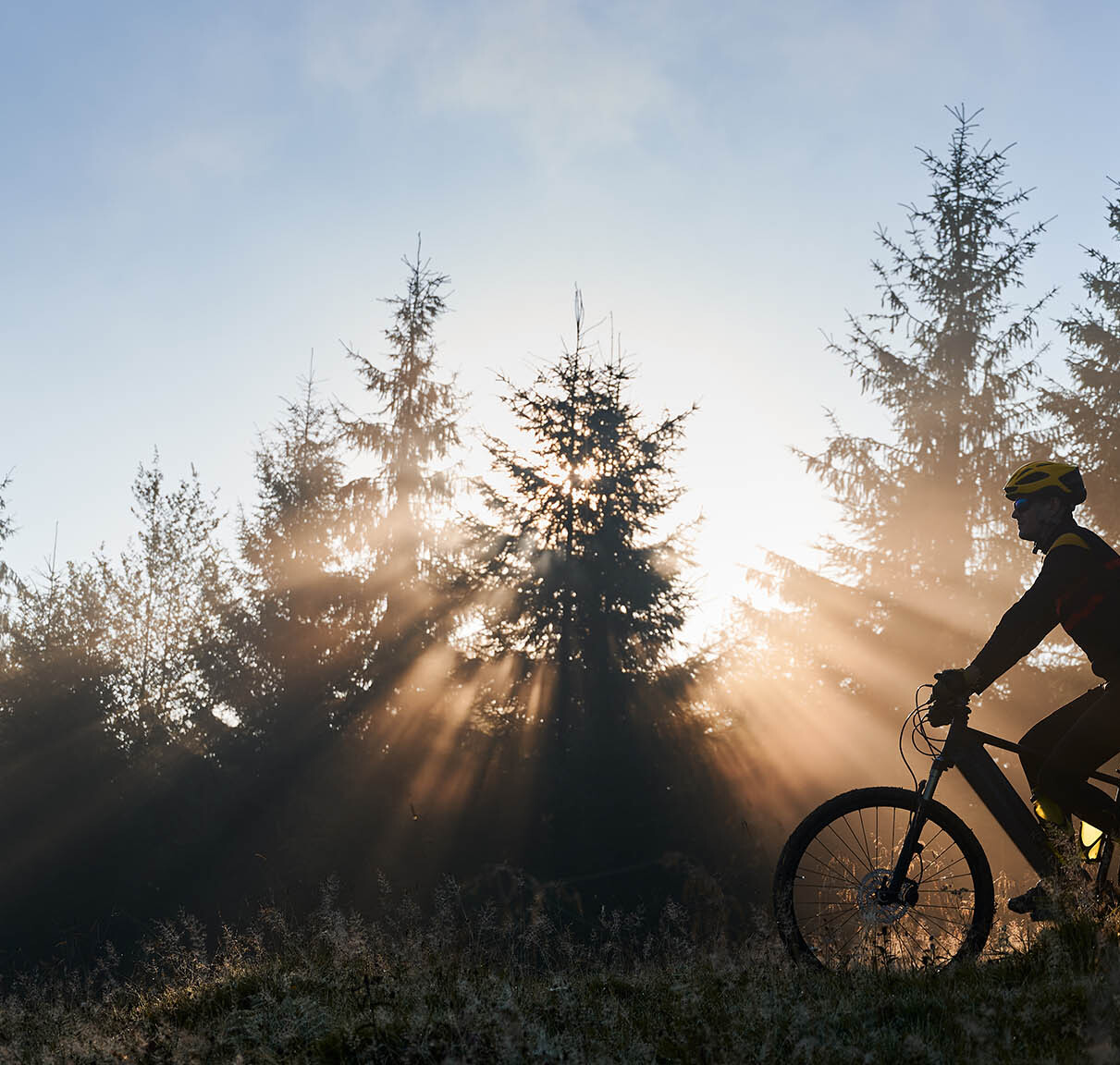young-man-riding-bicycle-mountains-early-morning